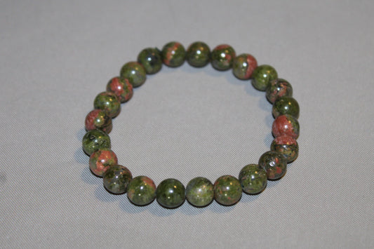 Find Emotional Balance and Spiritual Growth with Unakite. This unique stone, made up of epidote, pink orthoclase feldspar, and quartz, promotes mental clarity and visualization. Associated with the zodiac sign of Scorpio, Unakite is said to enhance the natural tendencies of this sign, such as their depth and intuition. Improve emotional balance, support your heart chakra, and deepen your spiritual journey with the healing properties of Unakite today.